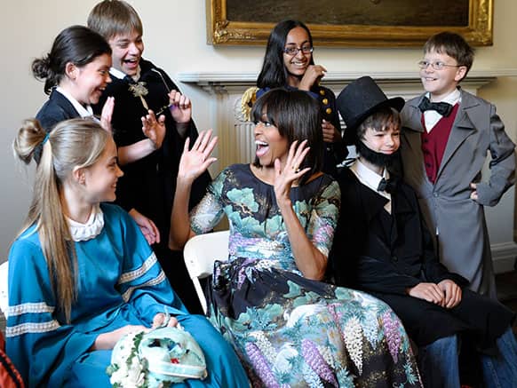 First lady Michelle Obama reacts as she surprises schoolchildren from Willow Springs Elementary School in Fairfax, Va., before they performed part of a play at the Decatur House, in Washington.