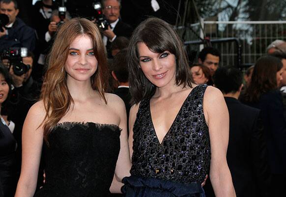 Models Barbara Palvin, left, and Milla Jovovich pose for photographers as they arrive for the screening of All Is Lost at the 66th international film festival, in Cannes.