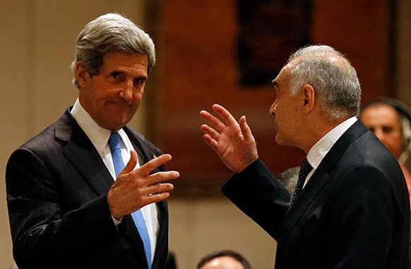US Secretary of State John Kerry talks with Egyptian Foreign Minister Mohamed Kamel Amr prior to the start of an meeting in Amman