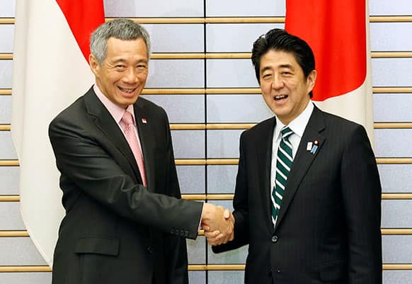 Singapore`s Prime Minister Lee Hsien Loong, left, shakes hands with Japanese counterpart Shinzo Abe at the star of their talks at Abe`s official residence in Tokyo.