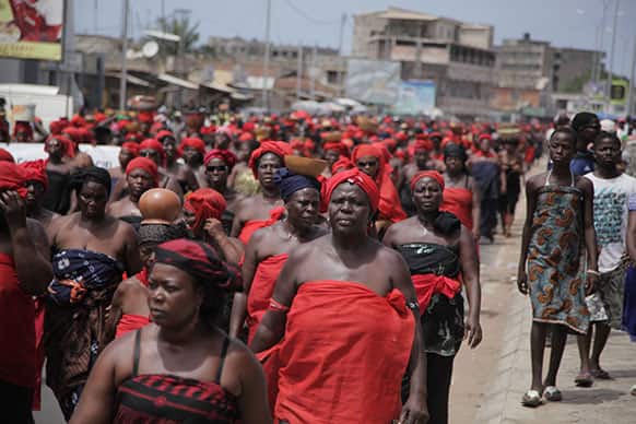 Thousands of women wearing red, a traditional color of mourning, march in protest over the death of opposition figure Etienne Yakanou, in Lome, Togo.
