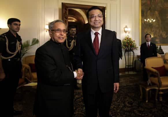 Chinese Premier Li Keqiang, poses with President Pranab Mukherjee before a meeting at the Indian Presidential Palace in New Delhi. Keqiang is on a three-day visit to discuss bilateral and trade ties.