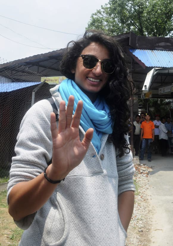 Raha Moharrak, who became the first Saudi Arabian woman to scale the world`s highest peak Mount Everest, waves to media after arriving at the Tribhuvan domestic airport in Katmandu, Nepal.