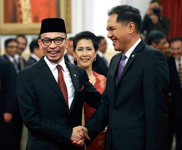 Newly appointed Indonesian Finance Minister Chatib Basri, left, is congratulated by Trade Minister Gita Wirjawan after his swearing in ceremony at the State Palace in Jakarta, Indonesia.