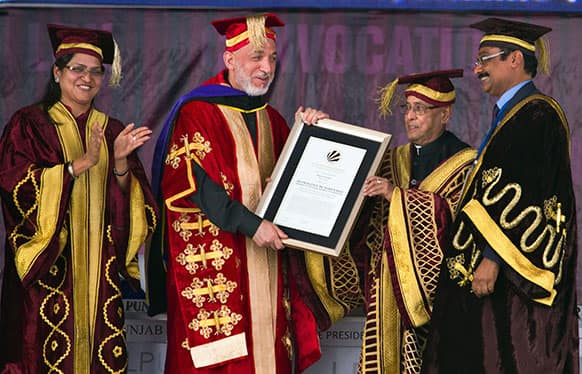 Afghan President Hamid Karzai, second left, receives an honorary degree from his Indian counterpart Pranab Mukherjee, second right, at the Lovely Professional University in Jalandhar, India.