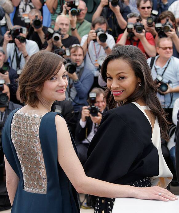 Actors Marion Cotillard, left, and Zoe Saldana pose for photographers during a photo call for the film Blood Ties at the 66th international film festival, in Cannes.