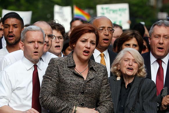 City Council Speaker Christine Quinn, center, joins other members of the LGBT community and their supporters gather to speak out after a string a bias attacks, including the fatal shooting of 32-year old Mark Carson on Saturday, during a rally in New York`s Greenwich Village.