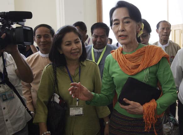 Myanmar Opposition Leader Aung San Suu Kyi, center, talks to journalists as she attends a session of Union Parliament at the Parliament building in Naypyitaw, Myanmar.
