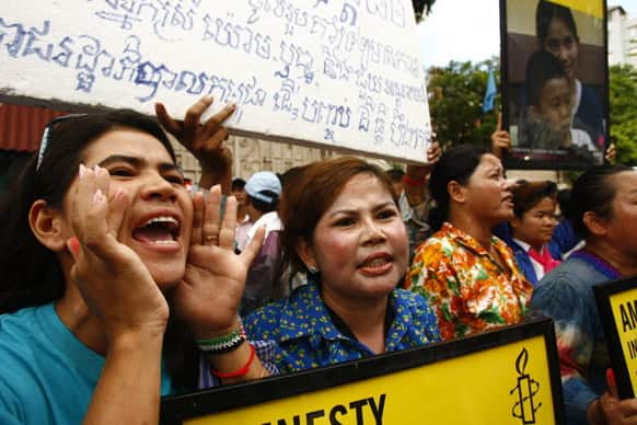 Tep Vanny, left, shouts slogans together with other villagers from Boeung Kak lake during a rally in front of Cambodia`s office of the High Commissioner for Human Rights, in Phnom Penh, Cambodia.