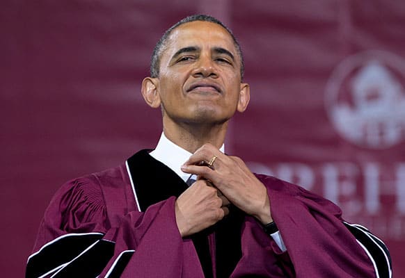 President Barack Obama straightens his tie before he receives an honorary doctorate of laws degree during the Morehouse College 129th Commencement ceremony, in Atlanta.