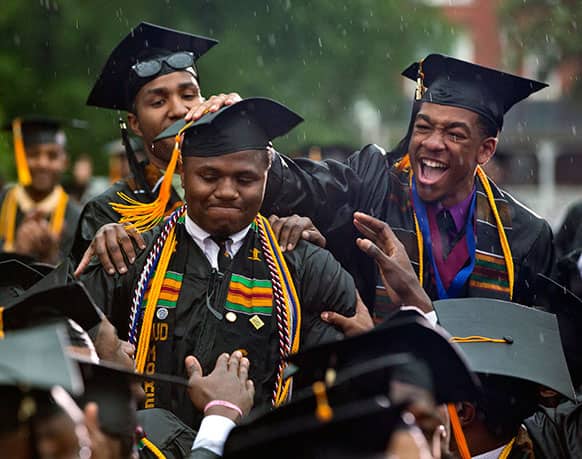 Graduate Leland Shelton, center, is congratulated as he is acknowledged by President Barack Obama during the 129th commencement ceremony address at Morehouse College, in Atlanta.