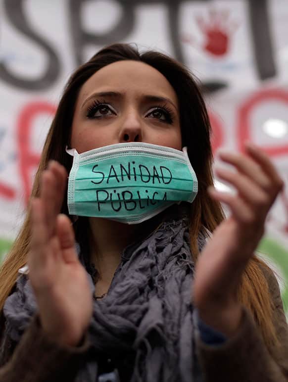 A protestor wears a mouth-guard reading