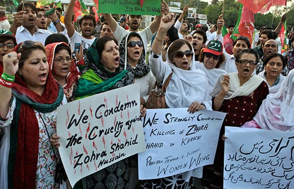 Pakistanis hold banners and chant slogans during a protest to condemn the killing of Zohra Shahid, a senior member of former Pakistani cricket star Imran Khan`s Pakistan Tehreek-e-Insaf party in Sindh, in Lahore, Pakistan.
