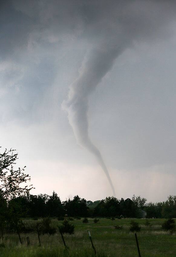 A tornado touches down southwest of Wichita, Kan. near the town of Viola on Sunday, May 19, 2013. The tornado was part of a line of storms that past through the central plains.