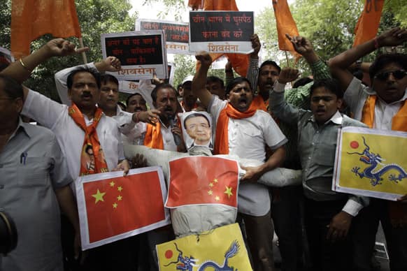 About two dozen members of Shiv Sena, a Hindu right-wing political party, prepare to burn an effigy of Chinese Premier Li Keqiang as they demonstrate near India`s Parliament, in New Delhi.