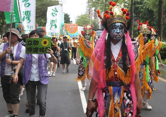 Taiwanese protesters dressed as local gods perform during a protest to demand that the government scrap a US$10 billion nuclear power plant that is nearly complete and slated to begin operation in two years in Taipei, Taiwan.
