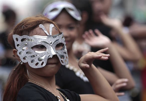 Filipino girls dressed in costume dance during a parade to mark the feast day Saint Rita de Cascia in suburban Paranaque City, south of Manila.