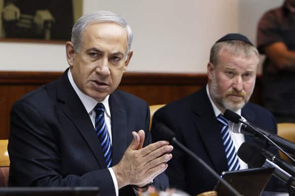 Israel`s Prime Minister Benjamin Netanyahu, speaks as he sits next to Cabinet Secretary Avichai Mandelblit during a weekly cabinet meeting in Jerusalem, Israel.