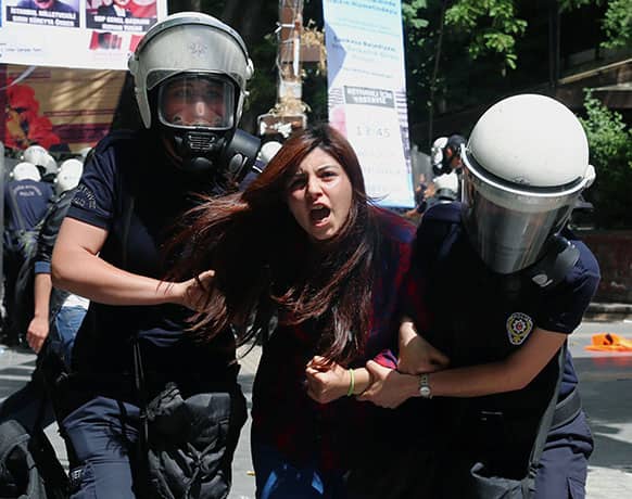 Riot police detain a demonstrator as they clash with demonstrators in Ankara, Turkey. Public outrage over two car bombs that killed 51 people and wounded over 100 near the border with Syria continues a week after the bloody incident.