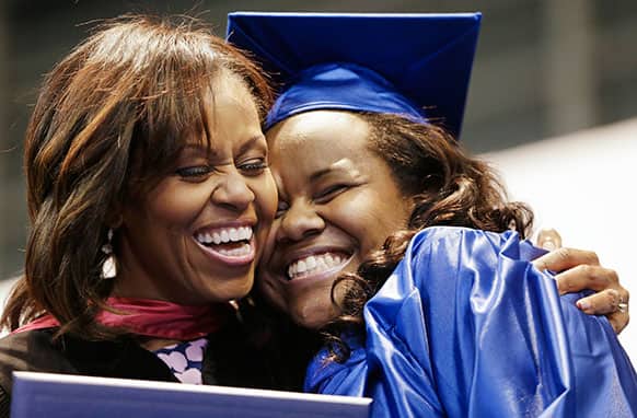 First lady Michelle Obama hugs Jenika Headley-Greene as Obama hands out diplomas during the graduation ceremony for Martin Luther King Jr. Academic Magnet High School, in Nashville, Tenn.