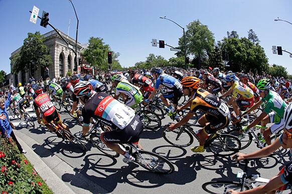 Riders huddle on a sharp turn during the stage 7 of the Tour of California cycling race in Livermore, Calif.