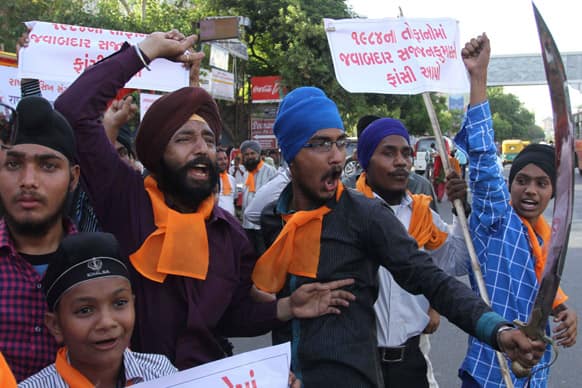 Sikhs shout slogans during a protest against the acquittal of ruling Congress party leader Sajjan Kumar, in Ahmadabad.