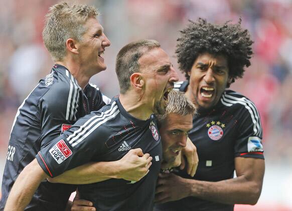 Bayern`s Bastian Schweinsteiger, from left, Franck Ribery of France, Philipp Lahm and Dante of Brazil celebrate after scoring challenge for the ball during the German first division Bundesliga soccer match between VfL Borussia Moenchengladbach and Bayern Munich in Moenchengladbach, Germany.