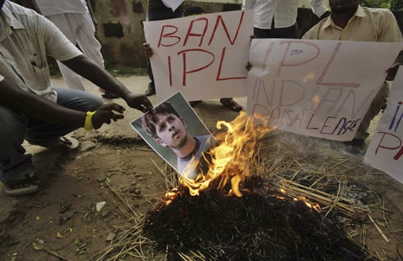 Activists of Kalinga Sena, a local political party, hold placards as they burn a poster of cricketer Shanthakumaran Sreesanth at a protest against spot fixing during the Indian Premier League (IPL) in Bhubaneswar.