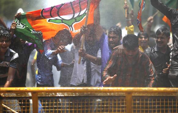 Supporters of Hindu nationalist and main opposition Bharatiya Janata Party (BJP) stage a protest rally against water scarcity in the city as police use water cannon to disperse them, in New Delhi.