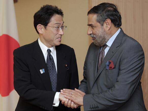 Indian Commerce and Industry Minister Anand Sharma, right, shakes hands with Japanese Foreign Minister Fumio Kishida prior to their meeting at Foreign Ministry in Tokyo.