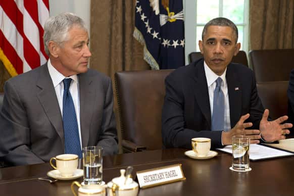 President Barack Obama meets with Defense Secretary Chuck Hagel along with Joint Chiefs Chairman Gen. Martin Dempsey and the service secretaries, service chiefs, and senior enlisted advisers to discuss sexual assault in the military in the Cabinet Room of the White House in Washington.