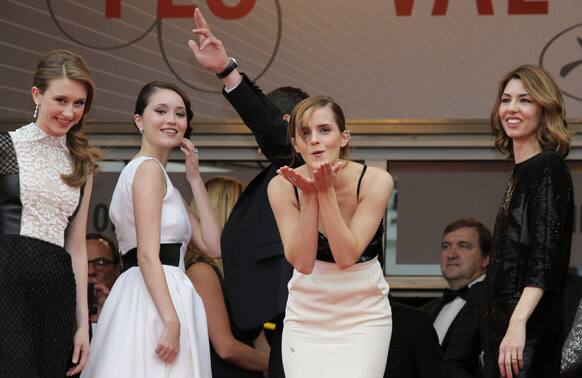 Actress Emma Watson, centre, gestures to photographers alongside actors Taissa Fariga, left, Katie Chang, second left, and director Sofia Coppola as they arrive for the screening of the film Young & Beautiful at the 66th international film festival, in Cannes.