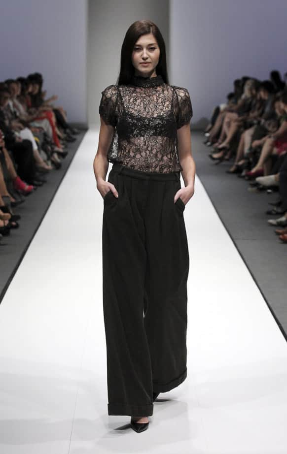 A model showcases an outfit from the A/W 2013 collection by Australian designer Collette Dinnigan during the annual Audi Fashion Festival, in Singapore.