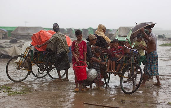 Internally displaced Rohingya people load rickshaws with children and belongings to leave their camp in Sittwe, northwestern Rakhine State, Myanmar.