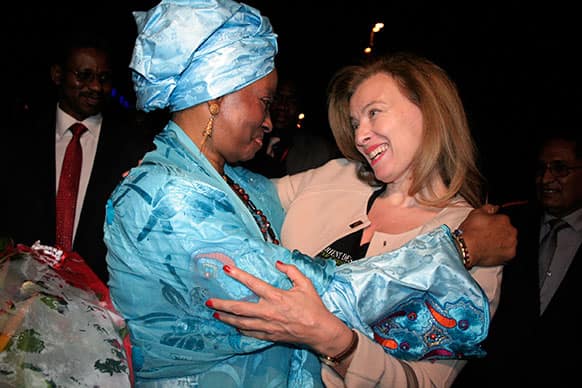 Valerie Trierweiler, right, companion of French President Francois Hollande, is greeted by Mali`s first lady Mintou Doucoure as she arrives at the airport in Bamako, Mali.