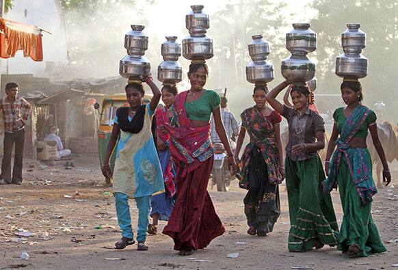 Indian village girls carry water in pitchers on their heads at Juval village, about 40 kilometers from Ahmadabad.