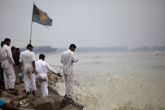 Bangladeshi marine sailors stand on the banks of the Bay of Bengal sea, as they prepare for the coming of tropical cyclone Mahasen, in Chittagong, Bangladesh.