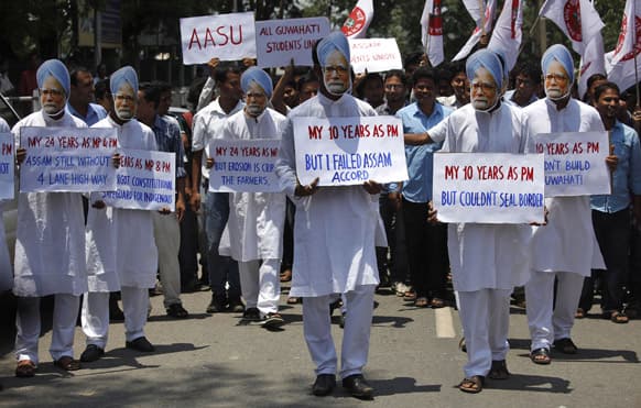 Student activists wear masks of Indian Prime Minister Manmohan Singh during a protest against Singh, claiming he has not done anything for the state of Assam, where he was nominated from, in Guwahati.
