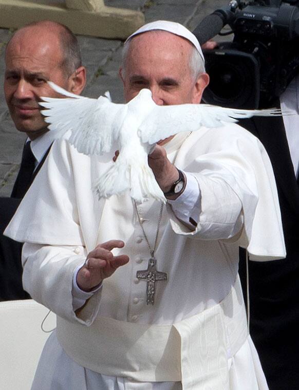 Pope Francis frees a dove during his weekly general audience in St. Peter Square at the Vatican.