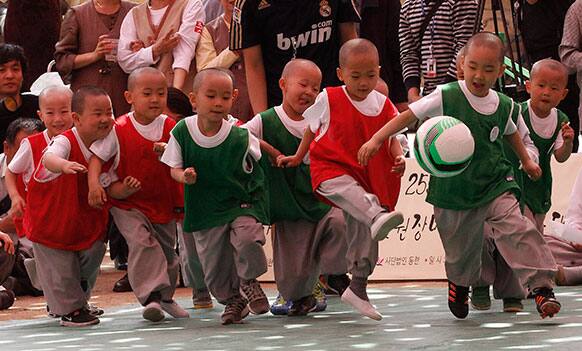 Shaven-headed young boys play the Dongjasung (little monk) soccer match to celebrate Buddha`s upcoming birthday on May 17 at Jogye temple in Seoul, South Korea.