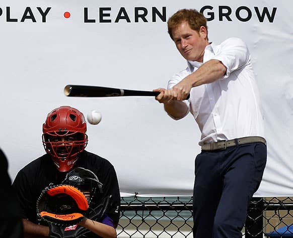 Britain`s Prince Harry hits a ball pitched to him by New York Yankees first baseman Mark Teixeira during a visit to Harlem RBI`s baseball program in New York, to launch a partnership between the organization, the Royal Foundation of the Duke and Duchess of Cambridge, and Prince Harry.