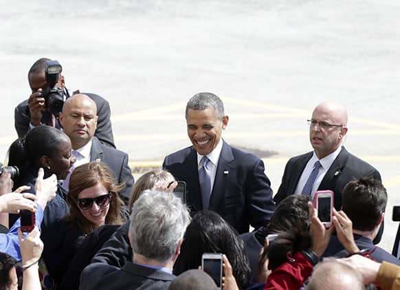 President Barack Obama greets people on the tarmac upon his arrival on Air Force One, at John F. Kennedy Airport in New York, before attending Democratic fundraisers.