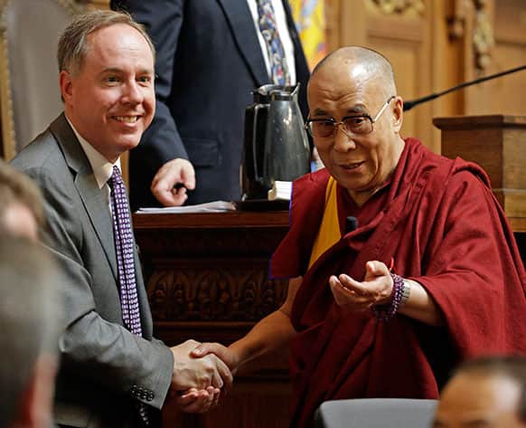 The Dalai Lama talks to Assembly Speaker Robin Vos after speaking to the Wisconsin state Assembly in Madison, Wis.