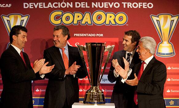 Mexico`s soccer coach Jose Manuel de La Torre, head of Santander Mexico Marcos Martinez, CONCACAF, Secretary General Enrique Sanz, and Justino Compean applaud as they stand around the new CONCACAF Copa Oro, or Gold Cup trophy during the unveiling ceremony.