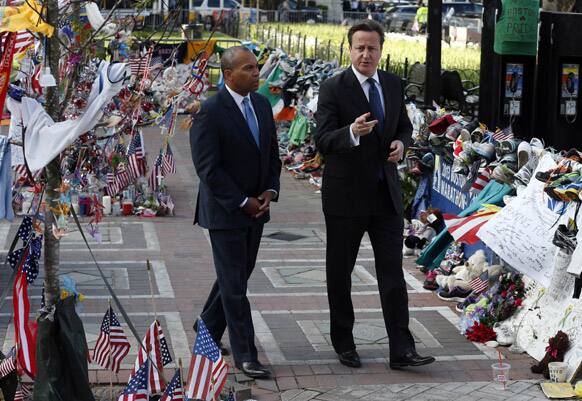 British Prime Minister David Cameron, right, and Massachusetts Gov. Deval Patrick visit the makeshift memorial to the Boston Marathon bombing victims in Copley Square in Boston.