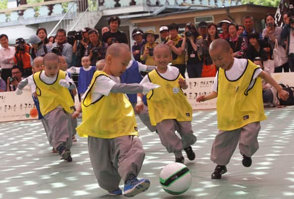 Shaven-headed young boys play the Dongjasung (little monk) soccer match to celebrate Buddha`s upcoming birthday on May 17 at Jogye temple in Seoul, South Korea.