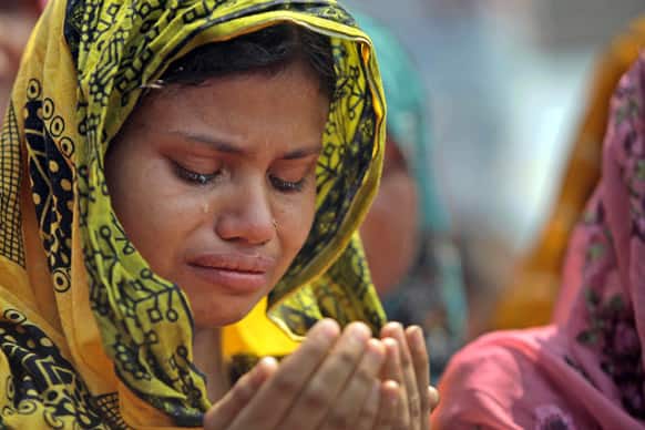 A family member of a victim cries as she offers prayers for the souls of the 1,127 people who died in the garment building structure collapse last month, in Savar, near Bangladesh.