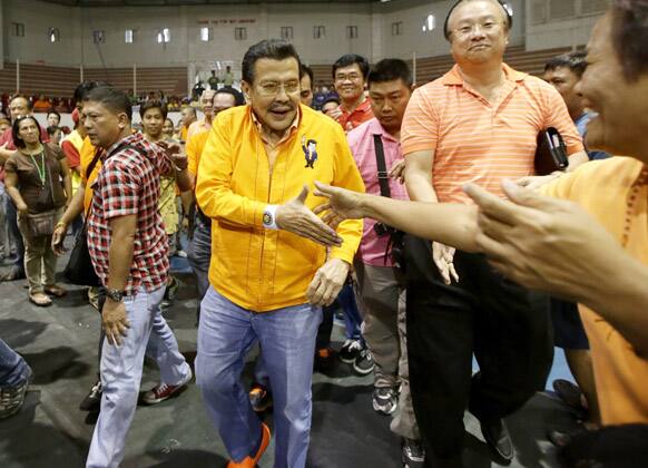 Former Philippine President Joseph Estra, who is now Manila`s new mayor-elect is greeted by supporters as he arrives at a stadium in Manila.