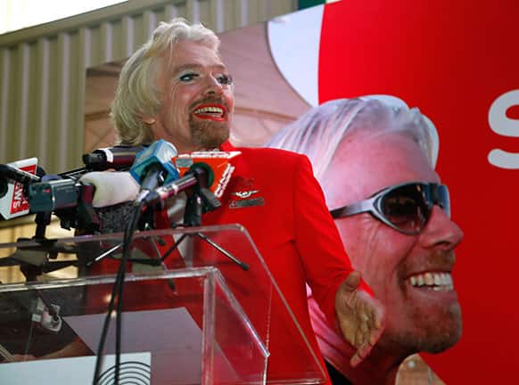 British entrepreneur Richard Branson speaks during a press conference while dressed up as an AirAsia flight attendant at a low cost carrier terminal in Malaysia.