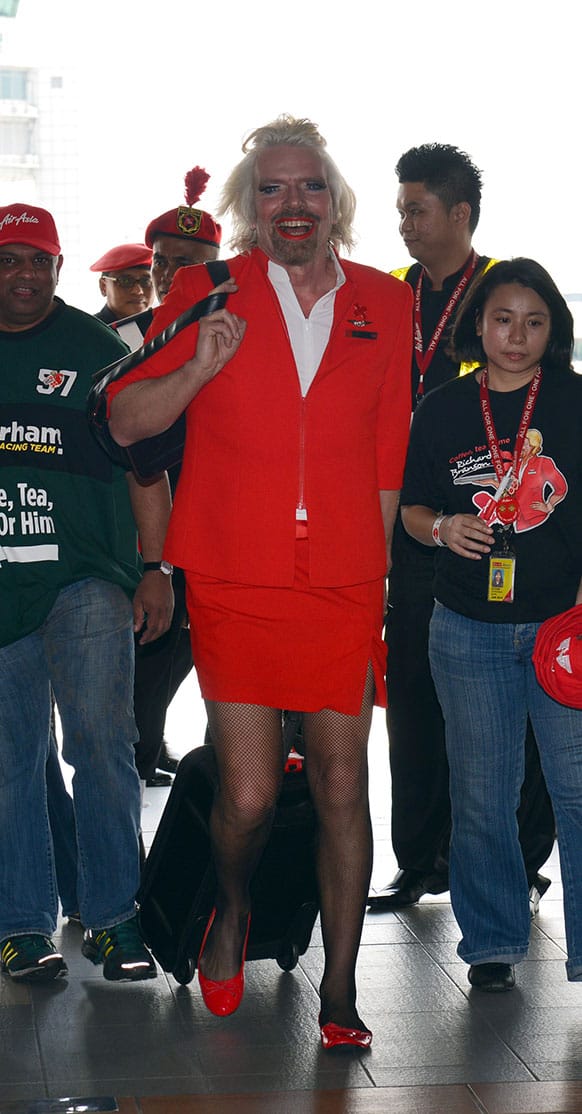 British entrepreneur Richard Branson arrives at a low cost carrier terminal dressed up as an AirAsia stewardess from a flight from Australia to Malaysia.